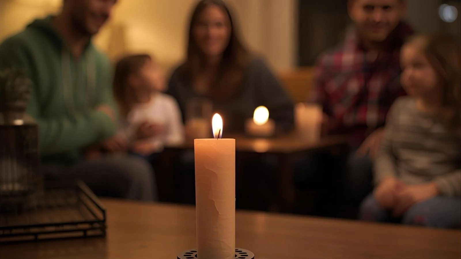 Small wish paper tube rising from a heat-safe platform during a home ritual.